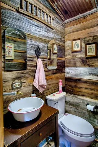 a bathroom with a granite countertop sink toilet and a mirror