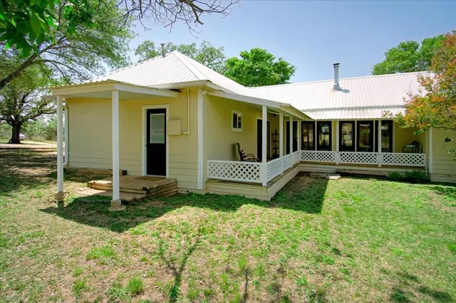 a kitchen with a stove window and cabinets