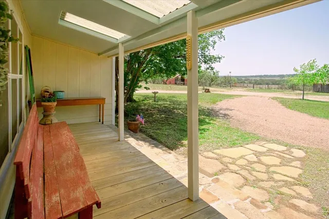 an aerial view of a house with a yard and lake view