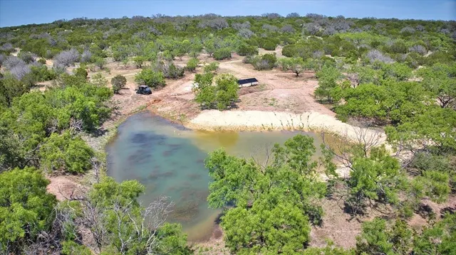 a living room with furniture a flat screen tv and a floor to ceiling window