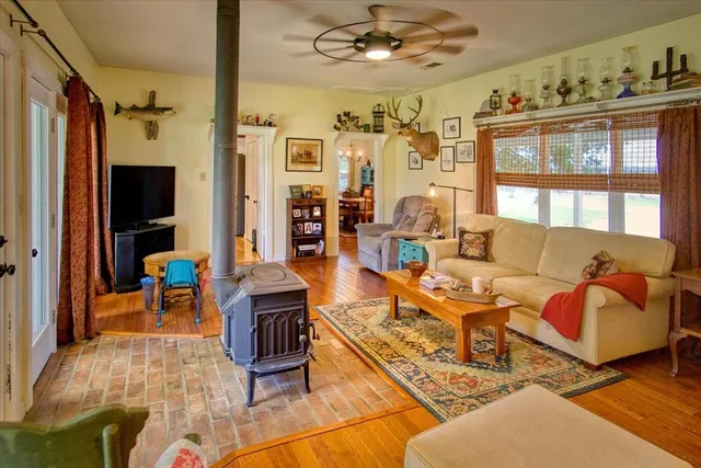 a kitchen with granite countertop a sink a stove and refrigerator