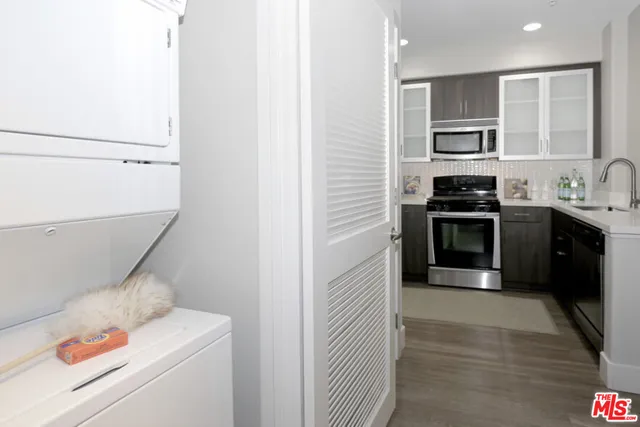 a kitchen with a sink and a stove top oven