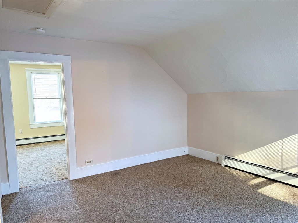 29 Fletcher Street, Unit 2 Ayer, MA 01432 - Photo 11 of 15 an empty room with windows
