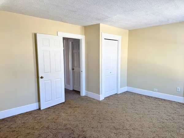 an empty room with closet area