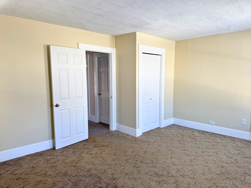 29 Fletcher Street, Unit 2 Ayer, MA 01432 - Photo 12 of 15 an empty room with closet area