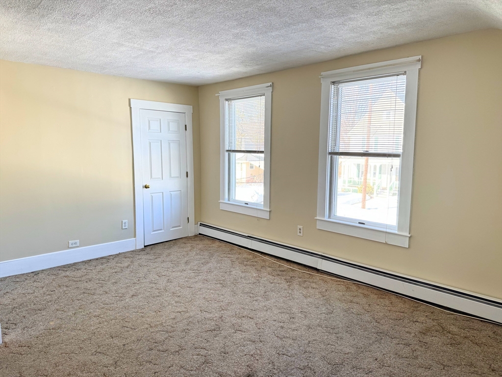 29 Fletcher Street, Unit 2 Ayer, MA 01432 - Photo 13 of 15 an empty room with windows
