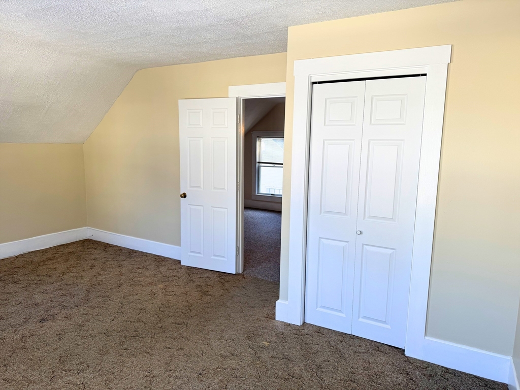 29 Fletcher Street, Unit 2 Ayer, MA 01432 - Photo 14 of 15 a view of an empty room with wooden floor