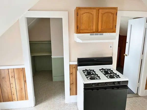a kitchen with a refrigerator and a stove