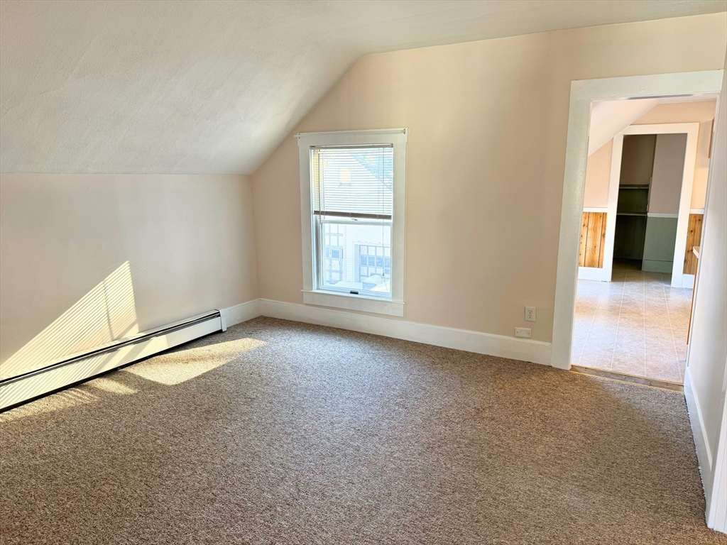 29 Fletcher Street, Unit 2 Ayer, MA 01432 - Photo 6 of 15 an empty room with windows and closet