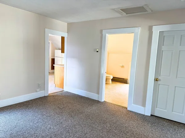 a view of an empty room and a window