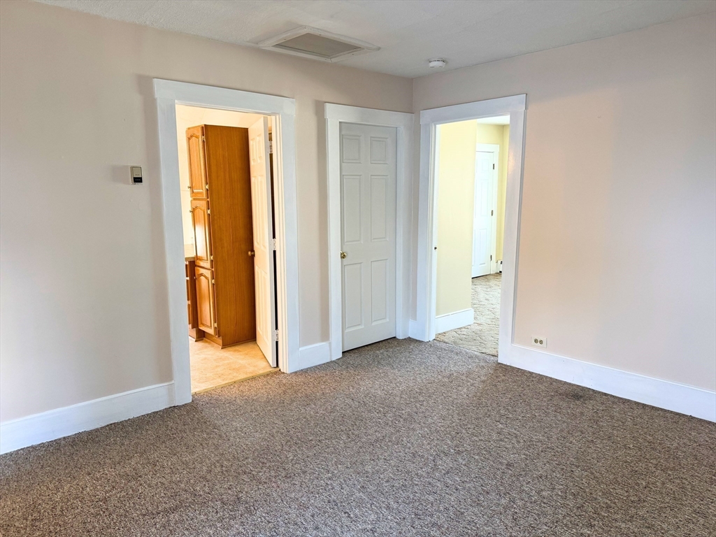 29 Fletcher Street, Unit 2 Ayer, MA 01432 - Photo 10 of 15 an empty room with closet and a bathroom