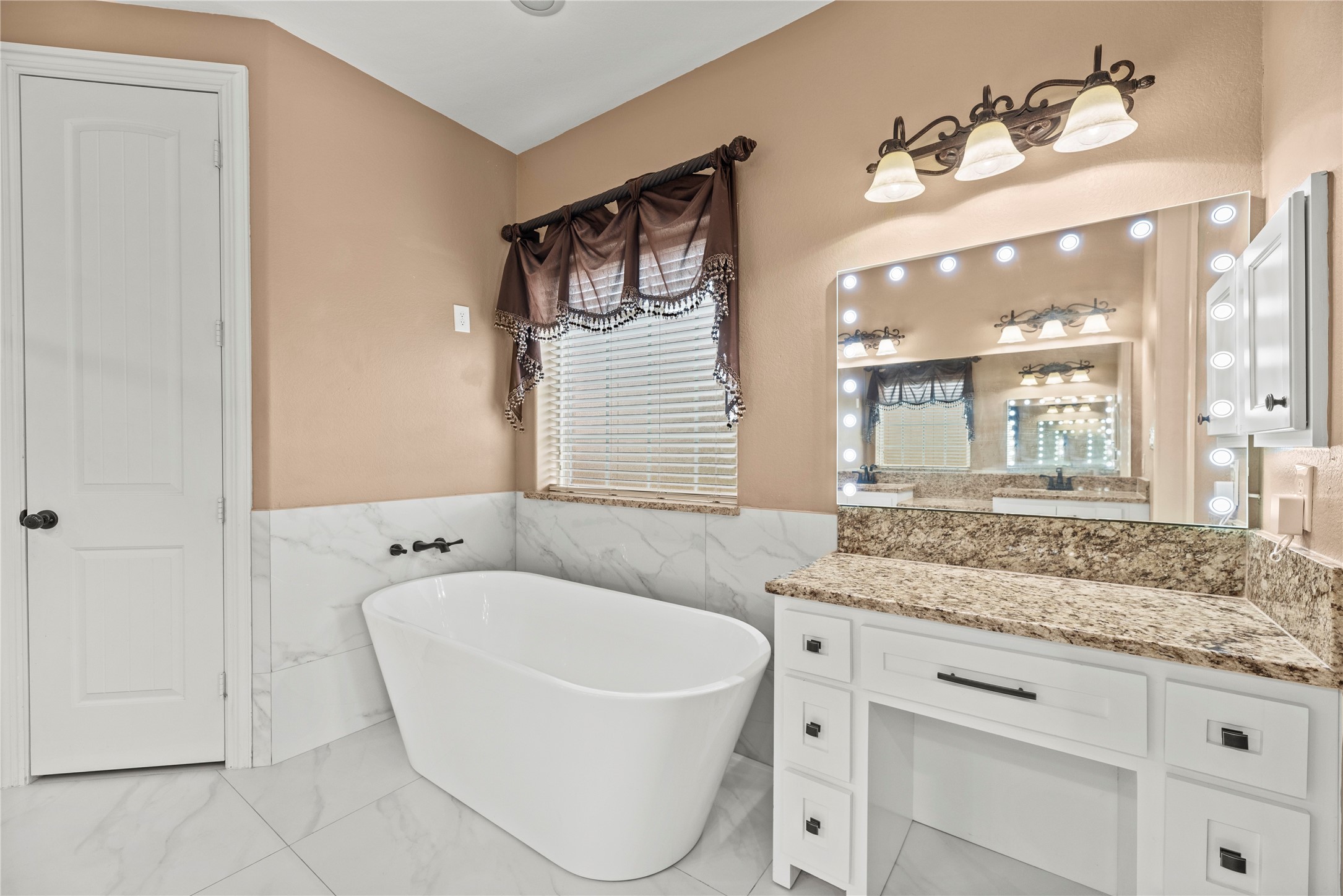 30914 Coco Street Cypress, TX 77433 - Photo 24 of 47 Soaking tub and makeup vanity with a lighted mirror.