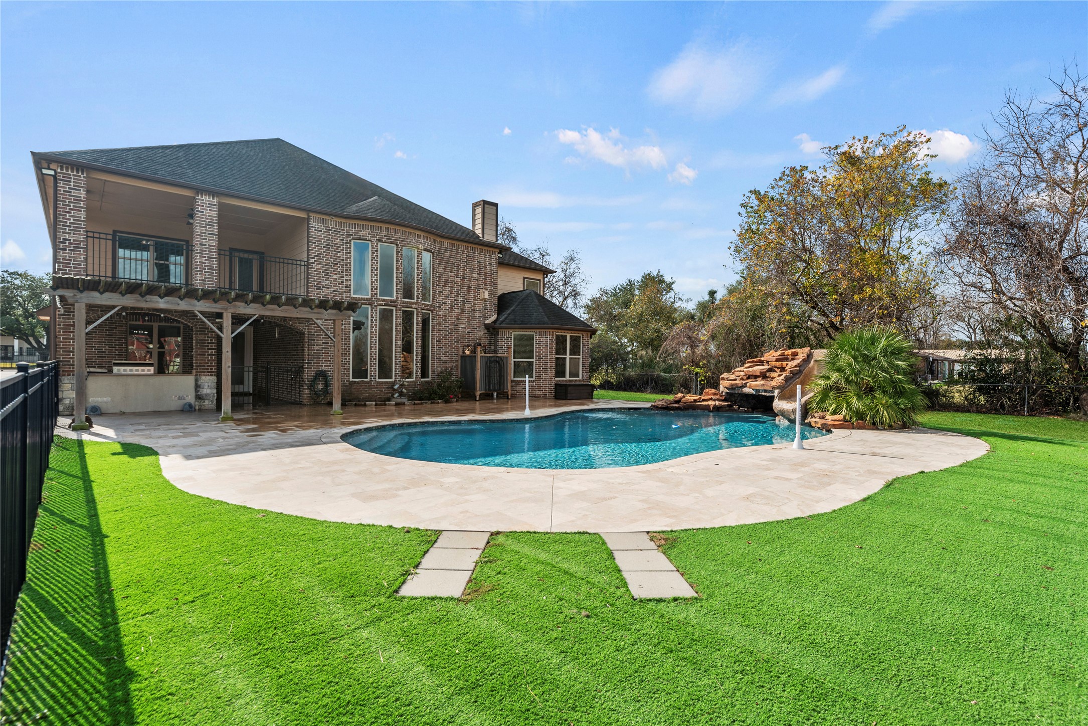 30914 Coco Street Cypress, TX 77433 - Photo 38 of 47 Low maintenance artificial turf around the pool.