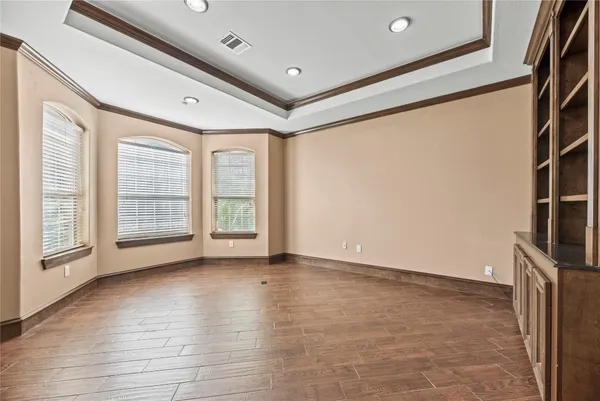a living room with furniture and large windows