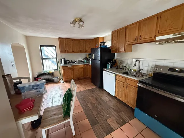 a kitchen with stainless steel appliances a stove a refrigerator and a sink
