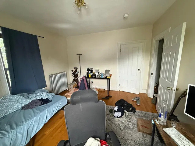 a room with furniture a flat screen tv and a window