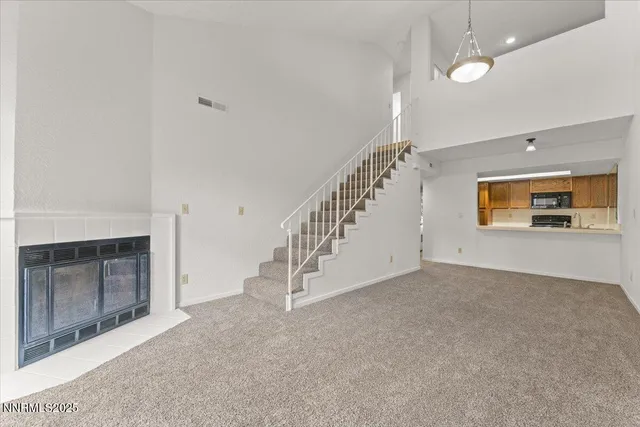 a view of empty room with fireplace and fan