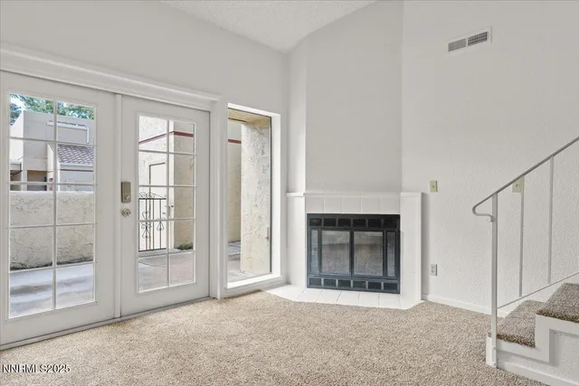 a view of a livingroom with an entryway and an empty room
