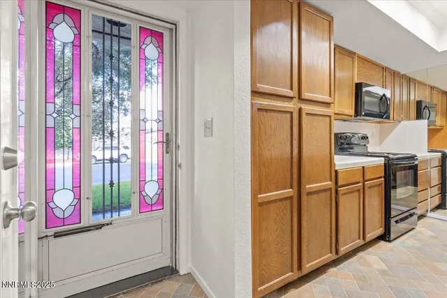 a kitchen with stainless steel appliances granite countertop a refrigerator and a stove top oven