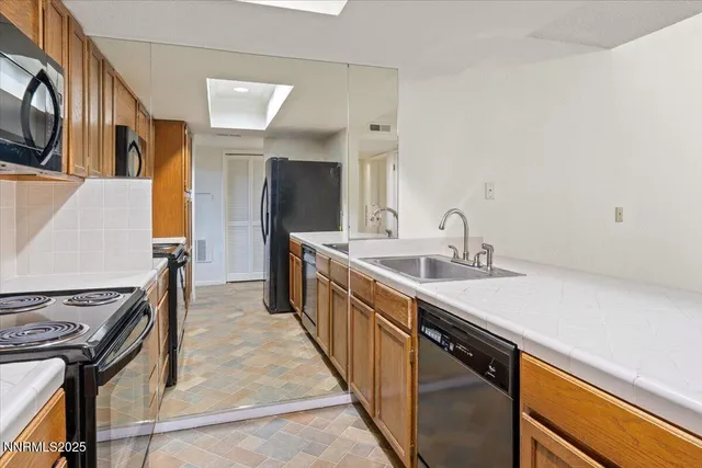 a kitchen with stainless steel appliances a sink and a stove