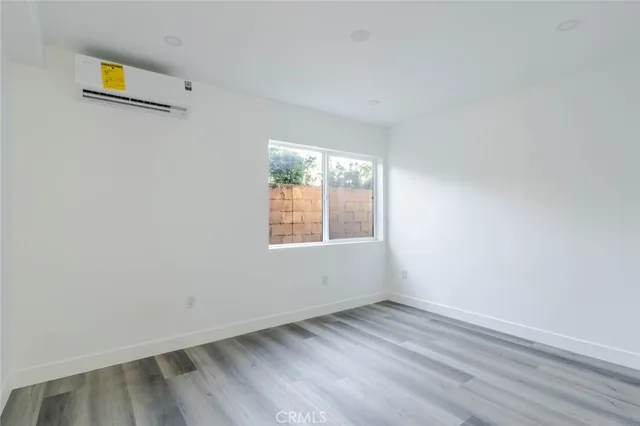 a view of an empty room and wooden floor