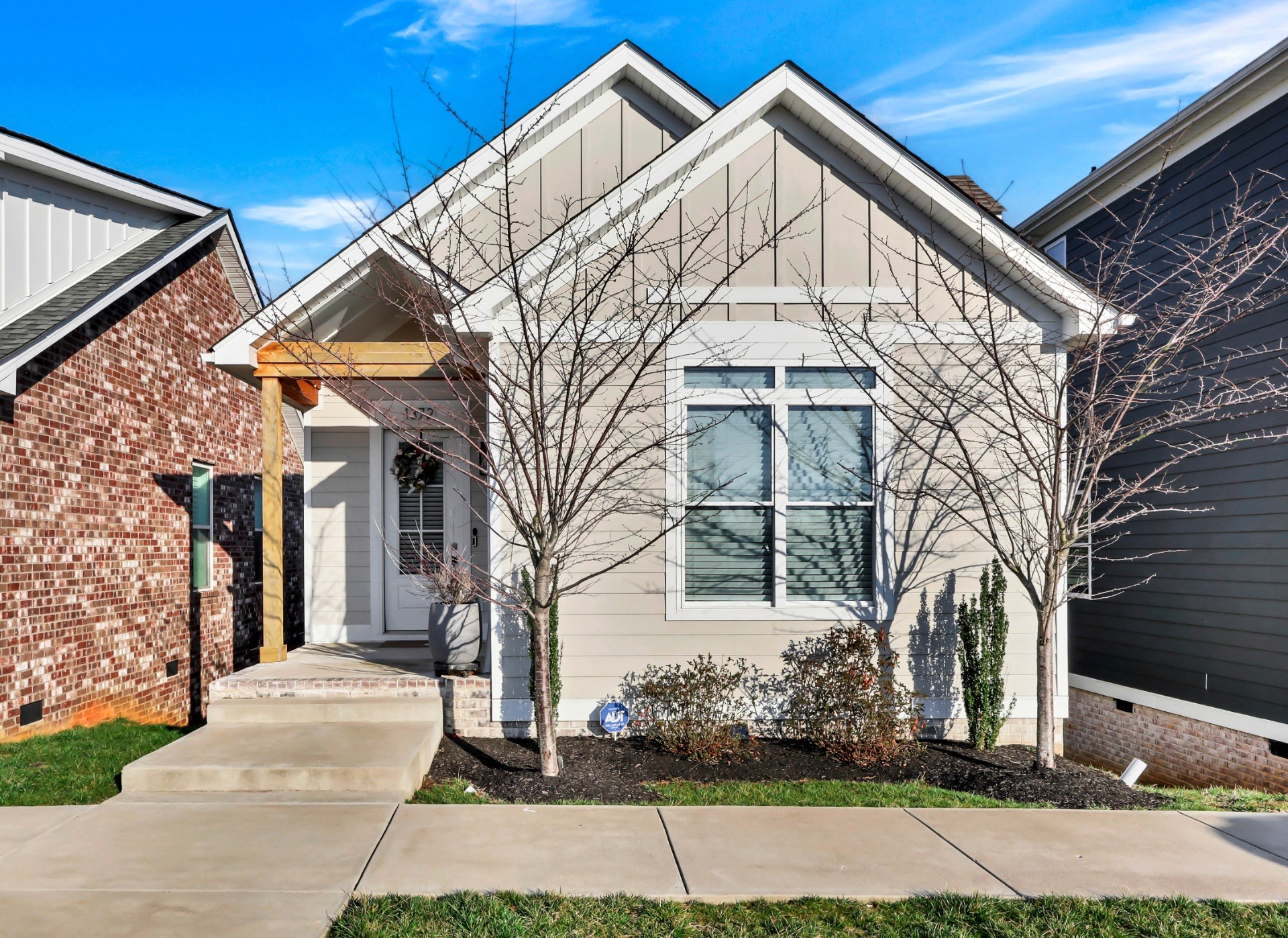 a view of white house with a yard