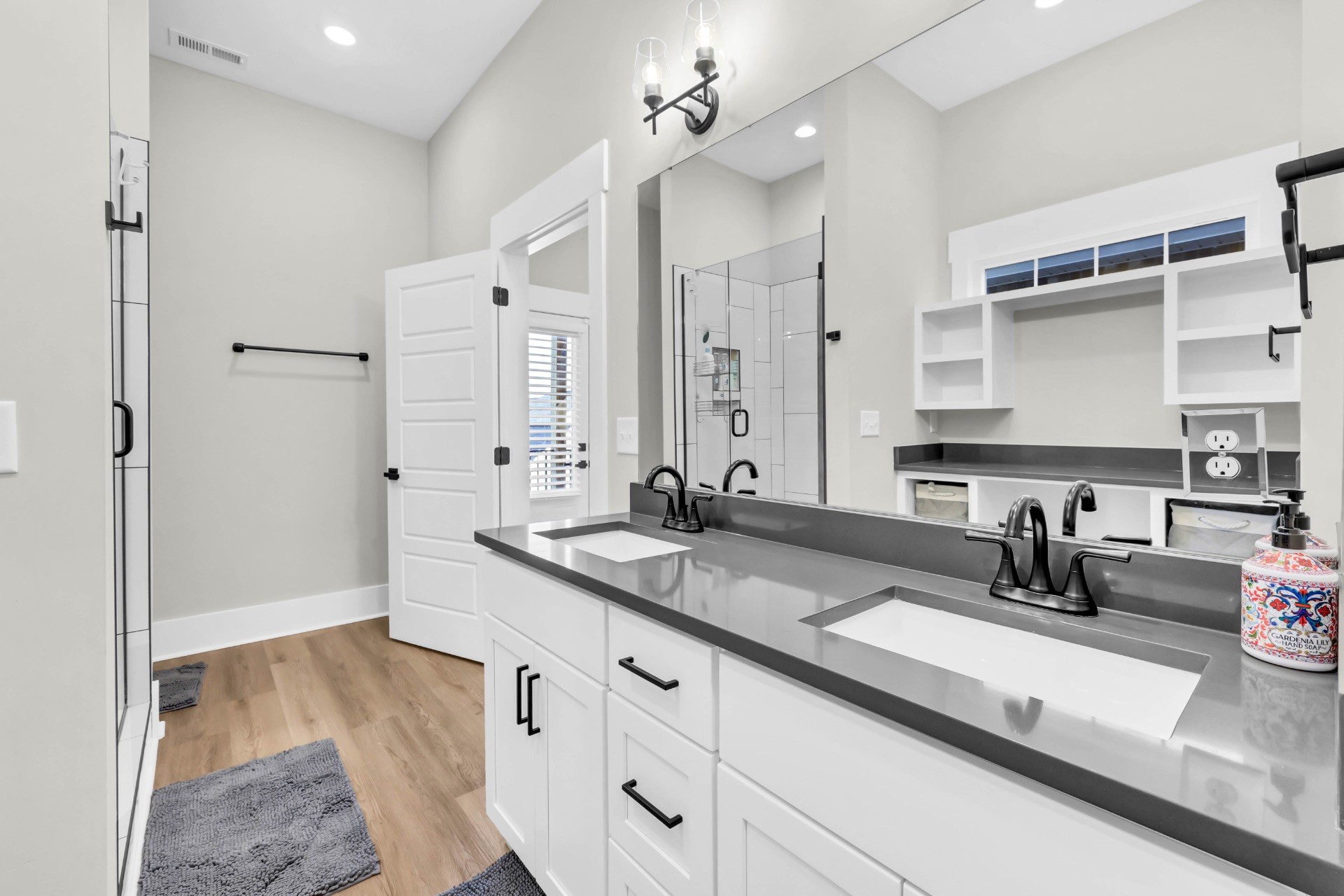 1372 Hicks Edgen Road Pleasant View, TN 37146 - Photo 19 of 37 a bathroom with double vanity sink a mirror and shower