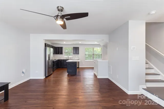 a view of a livingroom with furniture hardwood floor and a ceiling fan