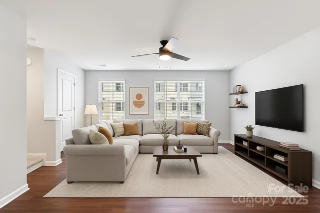 a living room with furniture and a flat screen tv