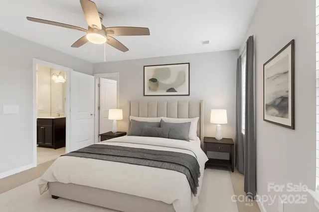 a bedroom with a large bed and a chandelier