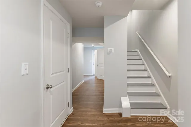 a view of a hallway with wooden floor and entryway