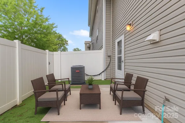 a view of a patio with a table and chairs and couches