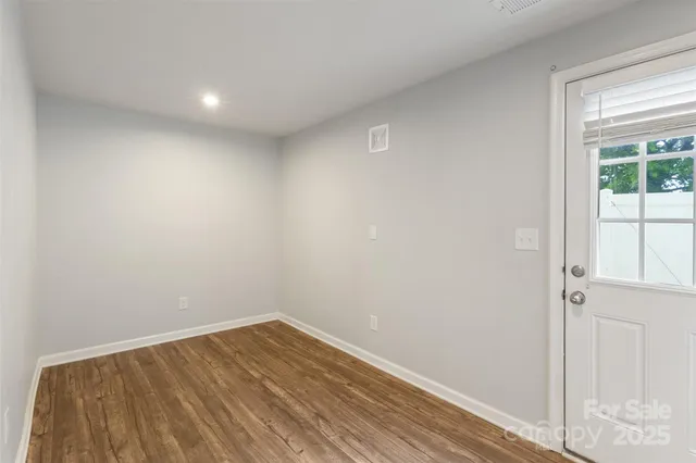 a view of room with wooden floor and window