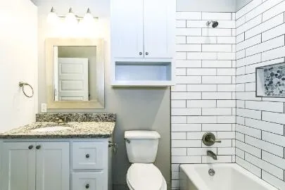 a bathroom with a sink a toilet and mirror