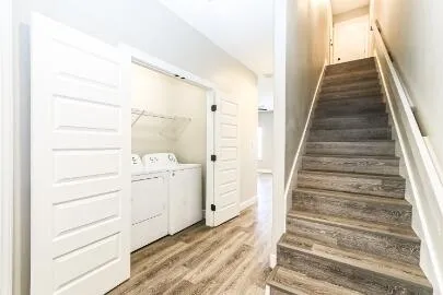 a view of a hallway with white cabinets and dryer