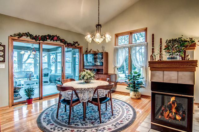 1437 Dresden Road Davis, IL 61019 - Photo 8 of 25 a dining room with furniture a floor to ceiling window and a fireplace