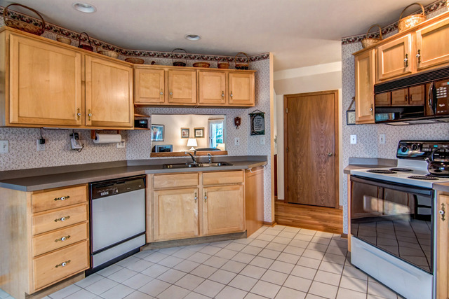 1437 Dresden Road Davis, IL 61019 - Photo 9 of 25 a kitchen with stainless steel appliances granite countertop a stove a sink and a refrigerator