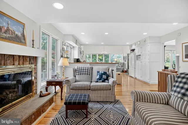 a kitchen with stainless steel appliances granite countertop table chairs refrigerator and sink