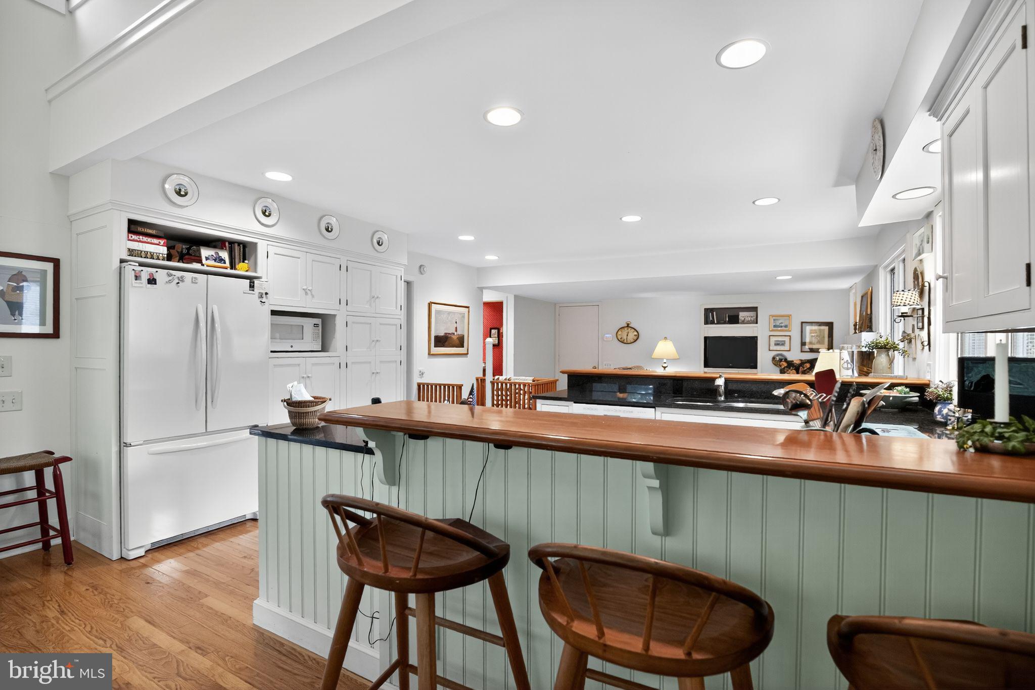1 Fox Pond Place Spring House, PA 19477 - Photo 14 of 56 a kitchen with stainless steel appliances granite countertop table chairs refrigerator and sink