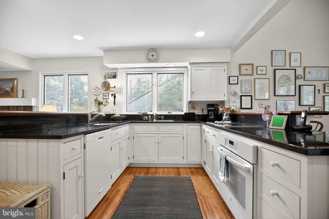 a view of a a dining room with furniture window and wooden floor