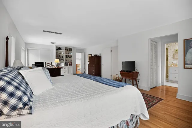 a bedroom with bed and a window