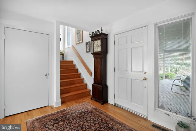 a view of entryway with wooden floor and stairs