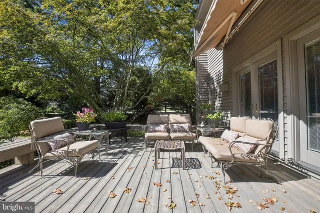 a view of swimming pool with outdoor seating and green space