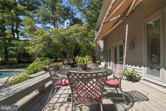 a view of backyard with swimming pool and seating space
