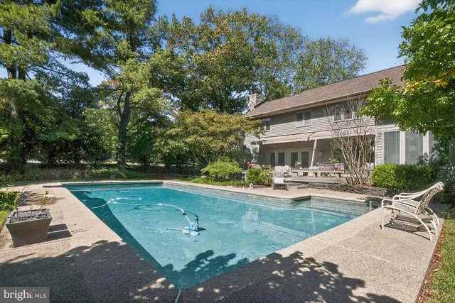 an aerial view of a house with yard swimming pool and outdoor seating