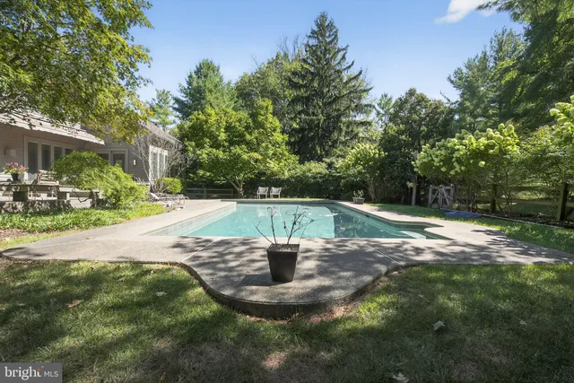 an aerial view of a house with a yard and garden
