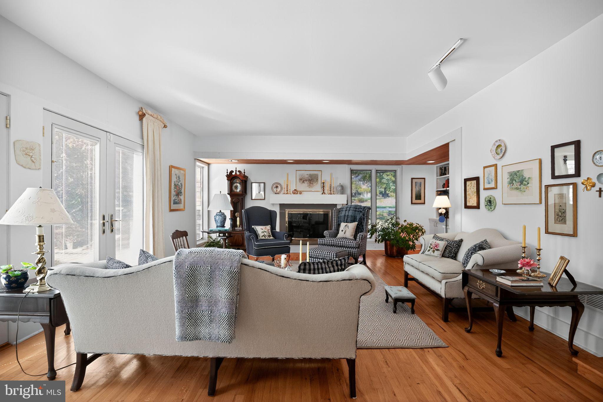 1 Fox Pond Place Spring House, PA 19477 - Photo 5 of 56 a living room with fireplace furniture and a large window