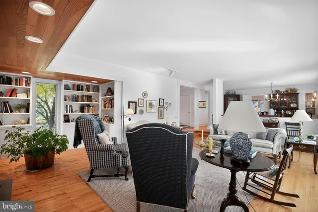 a dining room with furniture a rug and a chandelier