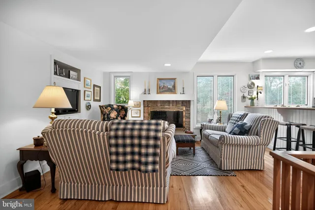 a living room with furniture a fireplace and a table