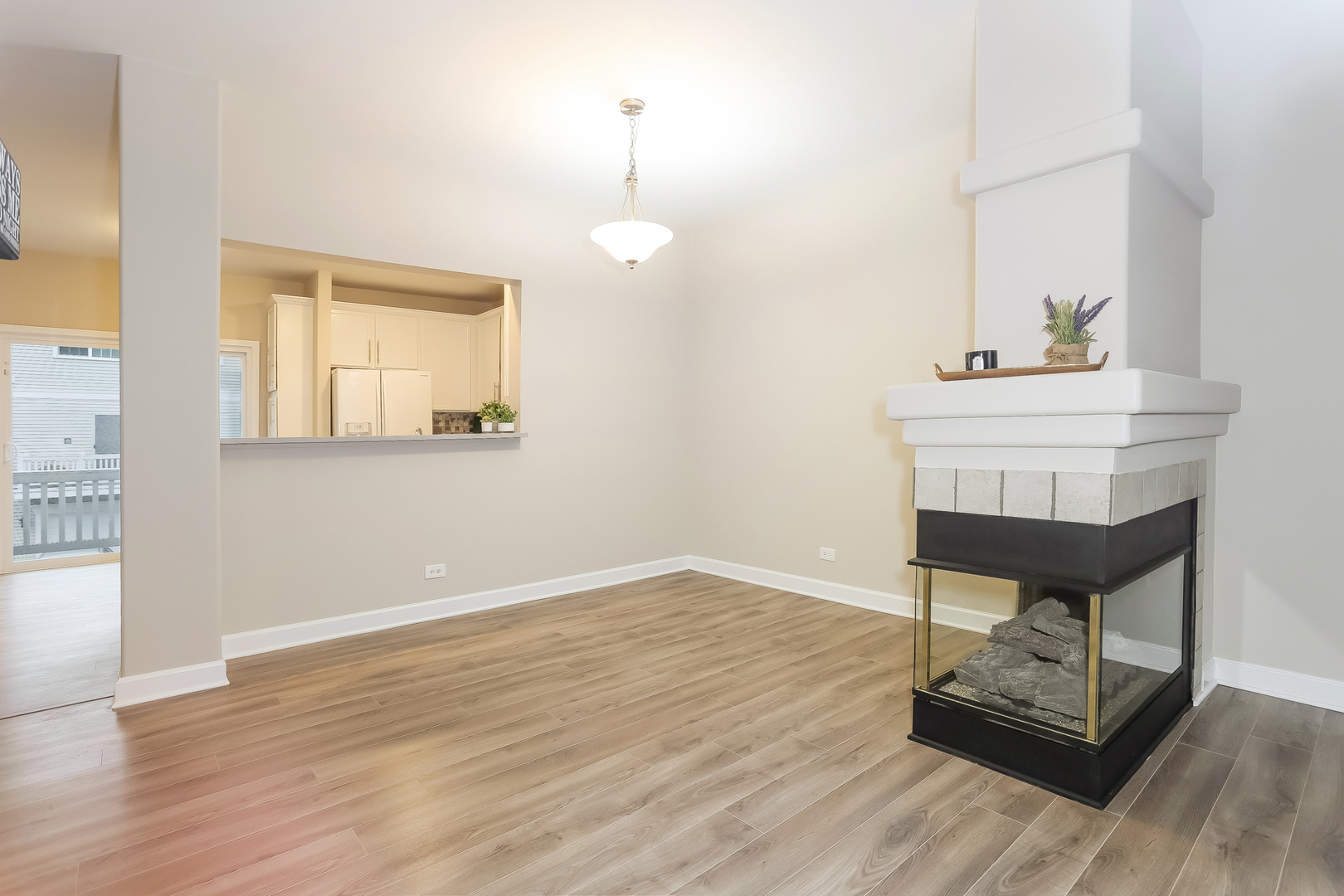 3462 Ravinia Circle Aurora, IL 60504 - Photo 4 of 17 a view of a room with wooden floor and a chandelier